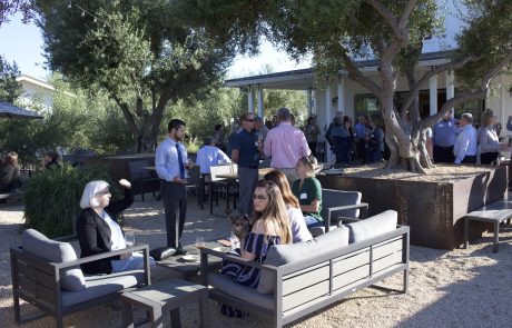 Members mingling at a social event at a winery